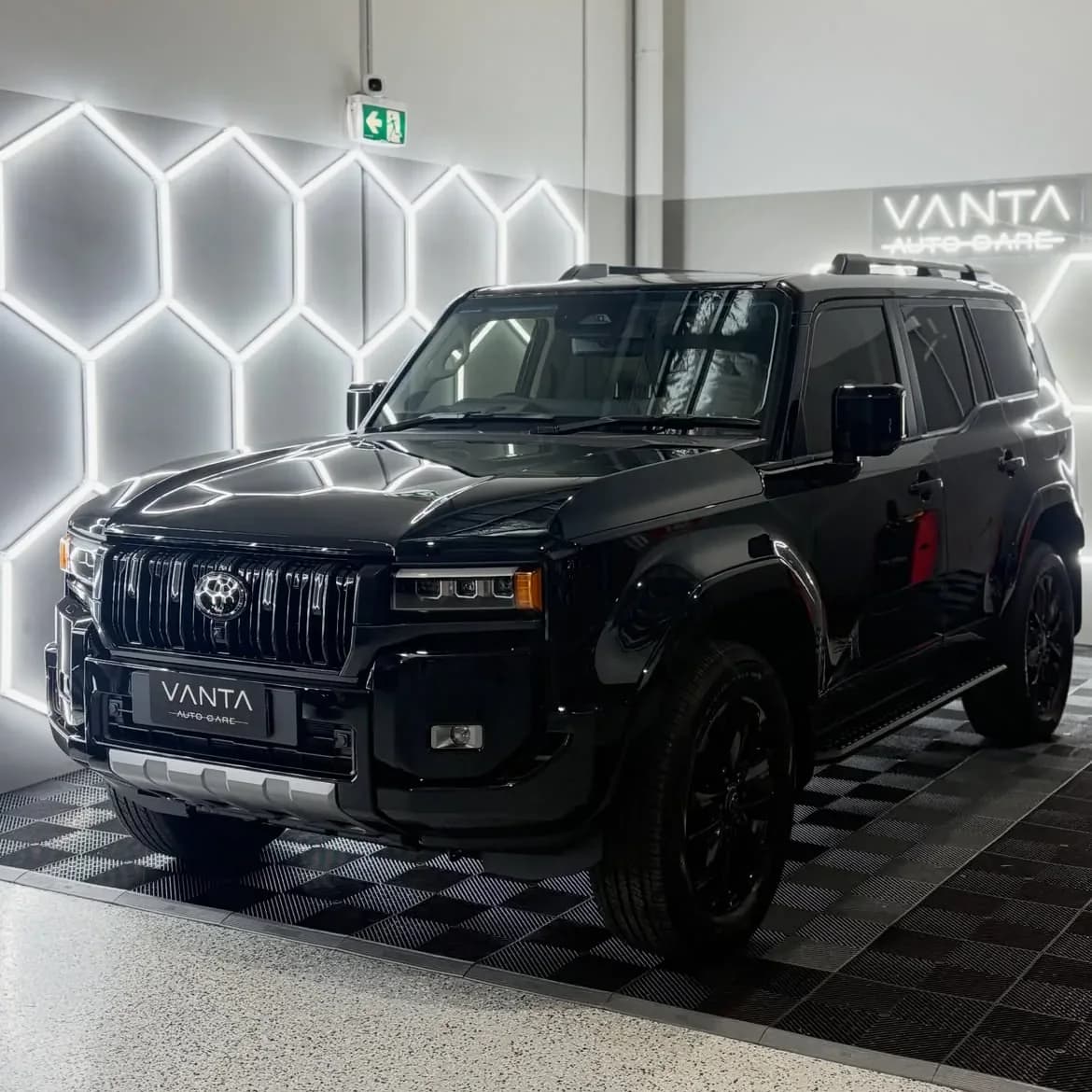Black Toyota LandCruiser finished under the hexagon lights in the Vanta Auto Care studio in Epping